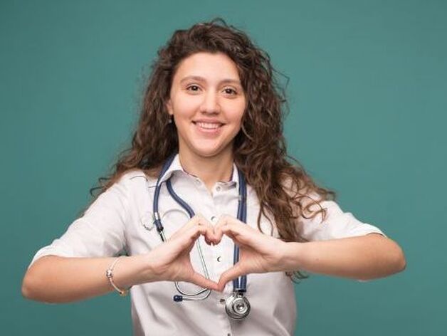 nurse makes heart with hands